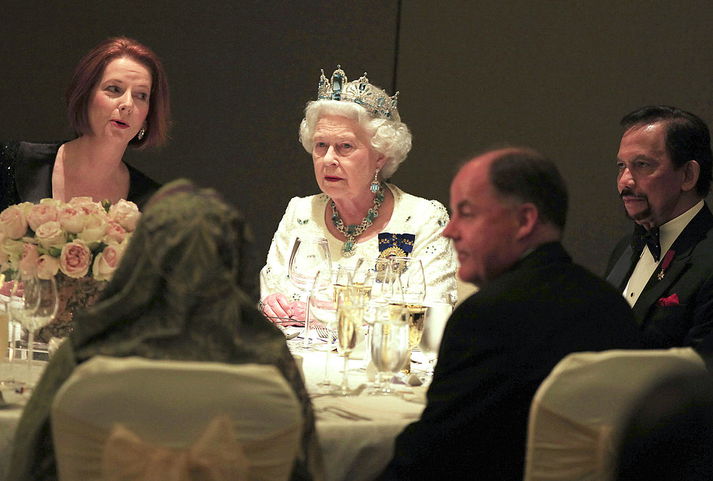 Britain’s Queen Elizabeth II (C) speaks Britain’s Queen Elizabeth II (C) speaks